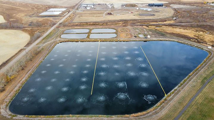 Aerial view of aerated lagoon wastewater treatment plant with circular basins